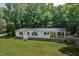 Inviting single Gathering home with a covered porch and freshly cut lawn surrounded by lush trees at 40 Raccoon Xing, Henderson, NC 27537