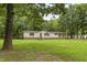 Lovely home nestled among mature trees, featuring a well-kept lawn at 40 Raccoon Xing, Henderson, NC 27537