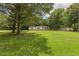 Picturesque view of home on expansive lot, surrounded by mature trees at 40 Raccoon Xing, Henderson, NC 27537