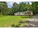Inviting single Gathering home surrounded by mature trees and sprawling lawn at 40 Raccoon Xing, Henderson, NC 27537