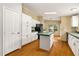 Well-lit kitchen featuring white cabinets, black appliances, and laminate flooring at 40 Raccoon Xing, Henderson, NC 27537