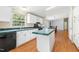 Functional kitchen with white cabinets, dark appliances, and an island at 40 Raccoon Xing, Henderson, NC 27537