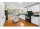 Bright kitchen with black appliances, white cabinets, and island, offering functionality and style at 40 Raccoon Xing, Henderson, NC 27537
