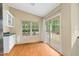 Inviting sunroom with sliding doors and built-in storage, offering a serene retreat at 40 Raccoon Xing, Henderson, NC 27537