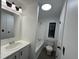 Bathroom features a bathtub and shower, with gray wood flooring and a bright vanity at 4025 Royal Dr, Franklinton, NC 27525