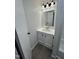 Well-lit bathroom featuring a neutral vanity, mirror, and lighting fixtures at 4025 Royal Dr, Franklinton, NC 27525