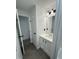 Bathroom sink and mirror with gray wood flooring, adjacent to closet and bathroom at 4025 Royal Dr, Franklinton, NC 27525