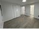 Bright bedroom featuring wood-look flooring, white walls, closet, and access to the bathroom at 4025 Royal Dr, Franklinton, NC 27525