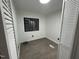 Bright bedroom features modern gray floors, white walls, and natural light from the window at 4025 Royal Dr, Franklinton, NC 27525