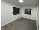 A bright bedroom with modern gray wood flooring and a window overlooking the outdoors at 4025 Royal Dr, Franklinton, NC 27525