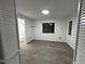 Well-lit bedroom features gray flooring, a window, and bathroom connected to the space at 4025 Royal Dr, Franklinton, NC 27525