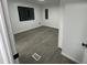 Bright bedroom featuring gray flooring, white walls, and trim, enhanced by natural light through the windows at 4025 Royal Dr, Franklinton, NC 27525