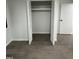 Bright bedroom closet with white bifold door featuring gray flooring at 4025 Royal Dr, Franklinton, NC 27525
