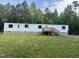 View of home with front yard, showing the wooden deck and stairs at 4025 Royal Dr, Franklinton, NC 27525