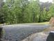 The gravel parking area is adjacent to a tree line at 4025 Royal Dr, Franklinton, NC 27525