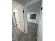 Hallway view of a bright bedroom with a window and gray wood flooring at 4025 Royal Dr, Franklinton, NC 27525