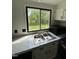 A close up of the Kitchen window and sink with view of the wooded area at 4025 Royal Dr, Franklinton, NC 27525