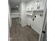 Well-lit laundry area with white cabinets, black hardware, and modern gray flooring at 4025 Royal Dr, Franklinton, NC 27525