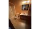 Bathroom with a tub, toilet, and vanity with a sink, and a mirror with light at 410 Carmil Dr, Selma, NC 27576