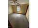 A view of a bedroom including a ceiling fan, window, wall paint, carpet, outlet, and base molding at 410 Carmil Dr, Selma, NC 27576
