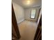 Simple bedroom featuring carpet, a window with blinds, and a door at 410 Carmil Dr, Selma, NC 27576