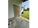 Home exterior featuring siding and brickwork, with a door leading to the outside at 410 Carmil Dr, Selma, NC 27576