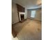 Cozy living room featuring a brick fireplace and mantle next to a window with natural light at 410 Carmil Dr, Selma, NC 27576