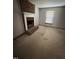 Cozy living room featuring a brick fireplace and mantle next to a window with natural light at 410 Carmil Dr, Selma, NC 27576