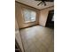 Empty room shows light from window, tiled floors and needed repairs at 410 Carmil Dr, Selma, NC 27576