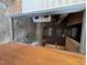 Unfinished room with exposed walls, pipes, hot water tank, and storage shelves at 410 Carmil Dr, Selma, NC 27576