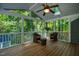 Inviting screened-in porch with ceiling fan offers relaxing outdoor living space at 4117 Olde Coach Rd, Durham, NC 27707