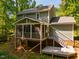A screened porch and deck extend the living space in this backyard at 4117 Olde Coach Rd, Durham, NC 27707