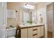 Well-lit bathroom with double sink vanity, white cabinets, and a large mirror at 4117 Olde Coach Rd, Durham, NC 27707
