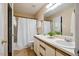 Well-lit bathroom features a double sink vanity with white countertop and cabinets at 4117 Olde Coach Rd, Durham, NC 27707