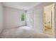 Neutral bedroom with window, carpeted floor, closet and an ensuite bathroom at 4117 Olde Coach Rd, Durham, NC 27707