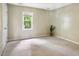 Neutral bedroom with window and carpeted floor at 4117 Olde Coach Rd, Durham, NC 27707