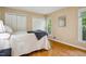 Bright bedroom features wood floors, closet, and double-hung windows offering natural light at 4117 Olde Coach Rd, Durham, NC 27707
