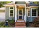 Charming front door with brick steps and small garden at 4117 Olde Coach Rd, Durham, NC 27707