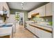 Bright kitchen features white appliances, cabinetry, and an undermount sink at 4117 Olde Coach Rd, Durham, NC 27707