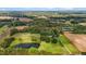 Aerial view of property with a pond and approximate property line indicated in red at 4345 Mcintyre Rd, Gibsonville, NC 27249