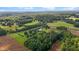 Expansive aerial view of a property featuring lush greenery, a serene pond, and farmland at 4345 Mcintyre Rd, Gibsonville, NC 27249