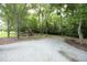 A spacious backyard with mature trees and a playset, offering plenty of room for outdoor activities and recreation at 4345 Mcintyre Rd, Gibsonville, NC 27249