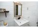 Bathroom showcasing a modern sink with a sleek faucet, complemented by a stylish mirror and white shiplap walls at 4345 Mcintyre Rd, Gibsonville, NC 27249
