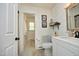 Bright bathroom featuring a modern vanity, decorative mirror, and a separate toilet area for added convenience at 4345 Mcintyre Rd, Gibsonville, NC 27249