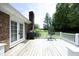 A spacious wooden deck with white railings, featuring a grill and outdoor seating, perfect for entertaining or relaxation at 4345 Mcintyre Rd, Gibsonville, NC 27249