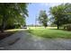 Long gravel driveway leading to a serene property with lush greenery at 4345 Mcintyre Rd, Gibsonville, NC 27249