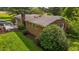 A charming brick home with a well-manicured lawn, a brick chimney and a inviting wooden deck on a sunny day at 4345 Mcintyre Rd, Gibsonville, NC 27249