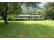 Well-maintained front yard with mature trees and bushes in front of the brick home at 4345 Mcintyre Rd, Gibsonville, NC 27249
