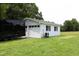 A detached two-car garage with white siding and two garage doors is situated in a grassy area at 4345 Mcintyre Rd, Gibsonville, NC 27249