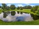 Scenic pond reflecting the sky, surrounded by lush greenery and trees at 4345 Mcintyre Rd, Gibsonville, NC 27249